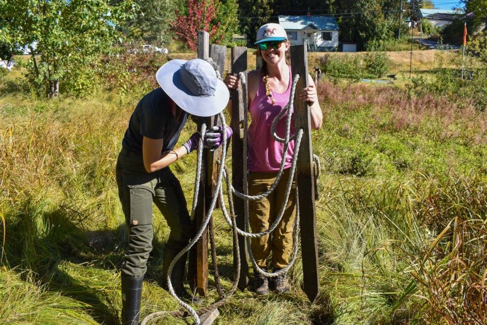 3-272-institute-participants-cora-and-rebekah-refencing-north-jubilee-wetland-as-it-expands-outward-alana-higginson-bcwf-22-23-min-scaled