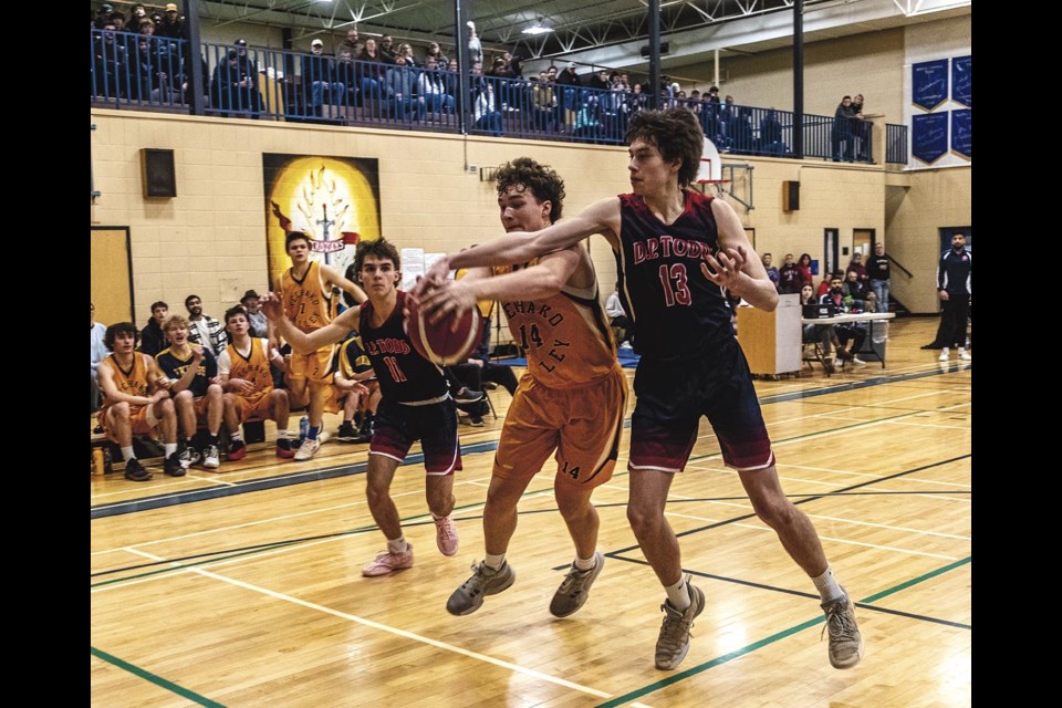 NVSS Vikings' Thomas Cross tries to hold on to the ball as D.P. Todd Trojans' Logan Slater tries to force it from his grip during the AA Senior Boys Zones Basketball final game Sunday, Feb 23, 2025 at D.P. Todd.