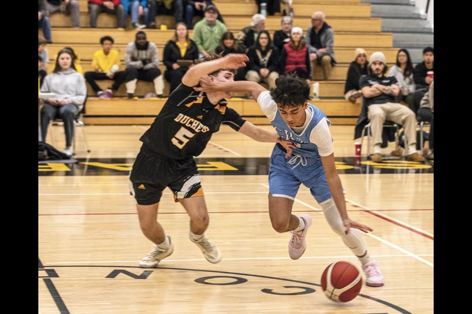 Cougar Jeona Gill and Condor Oliver Provencher battle for dominance as Gill tries to make his way around Provencher during the AAA North Central Zone final at Duchess Park Saturday Feb 22.
