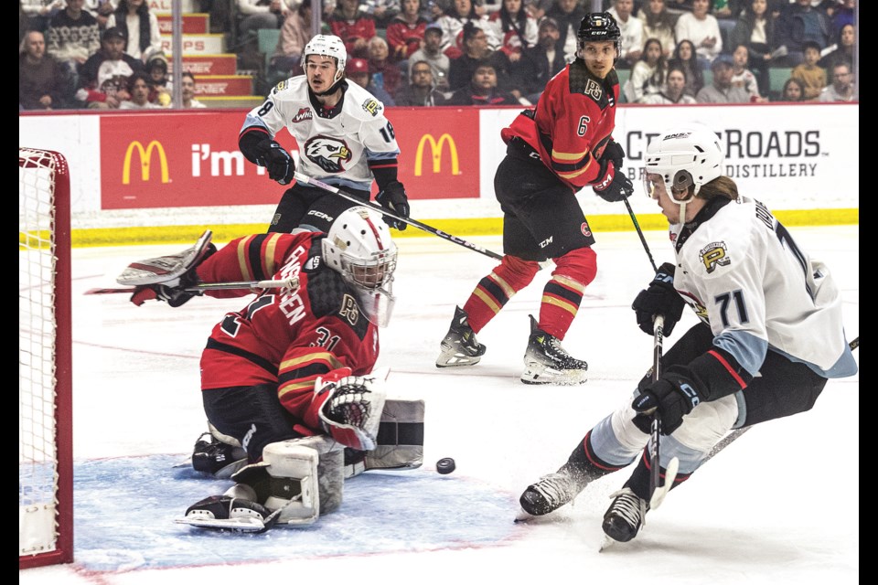 Cougars goalie Josh Ravensbergen blocks a shot from Portland Winterhawks forward Josh Davies during first-period action in Game 6 of the Western Conference final at CN Centre in Prince George, B.C. on Monday, May 6, 2024. Portland won the game 2-1 in double overtime, taking the series 4-2.
