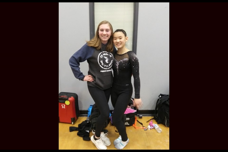 Alia Wilson (right) stands with her teammate at the 2019 B.C. Championships in Coquitlam (via Facebook/Prince George Gymnastics)