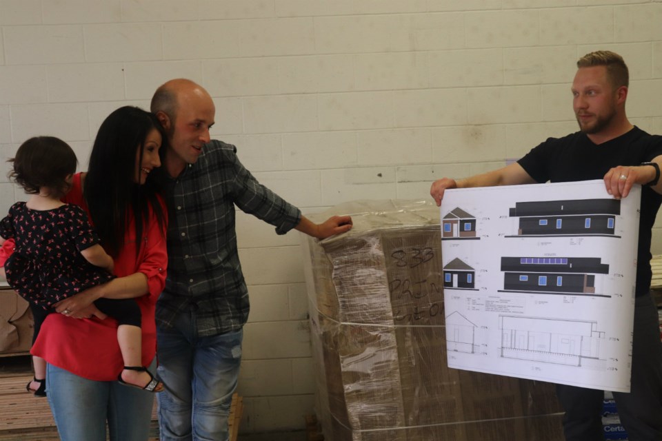 Chris and Amanda Sopel take their first look at the plans for their free house as the winners of the Welcome Home, Pay It Forward initiative (via Kyle Balzer)