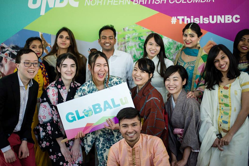 Students pose together to celebrate Globalu week. (via UNBC)