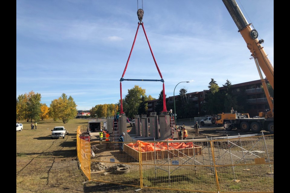 Crews work to install four sections of concrete chambers to replace the old sewer pipe that caused the sinkhole. (via Hanna Petersen)