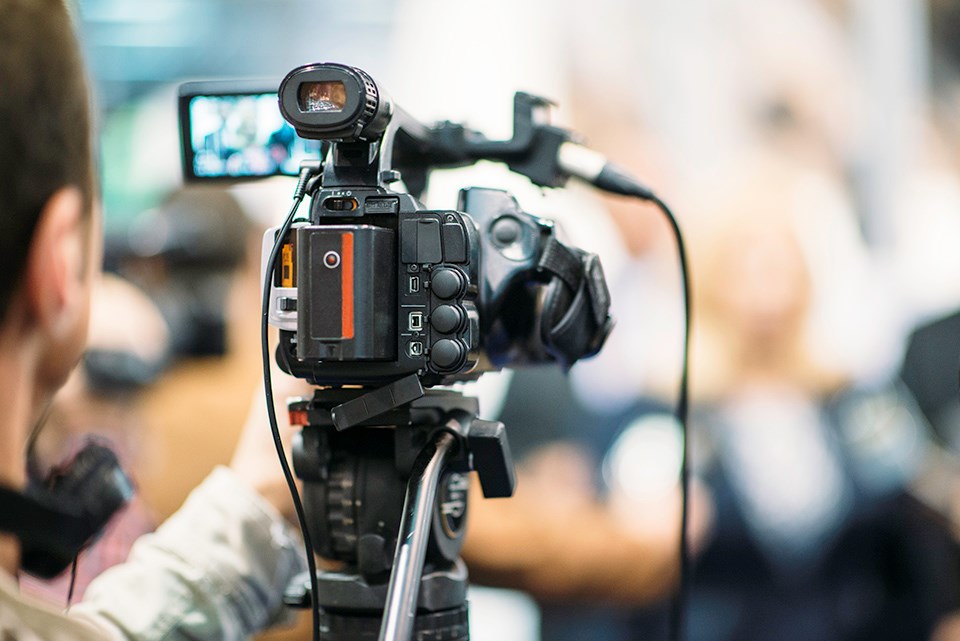 Camera person filming an interview