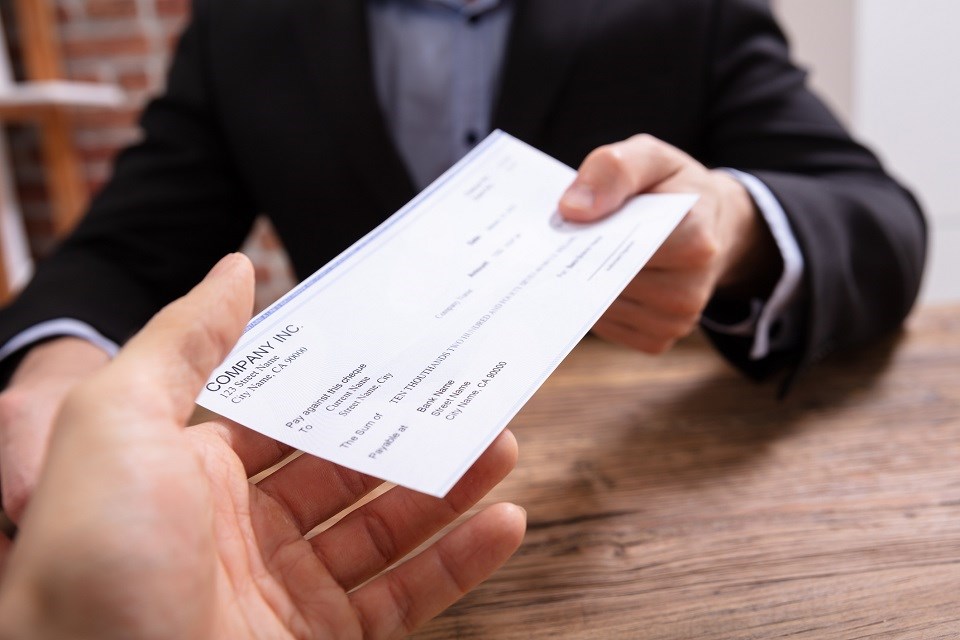 Handing a cheque - Getty Images