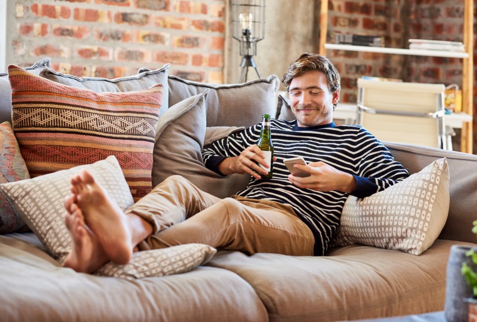 Man with beer and phone getty