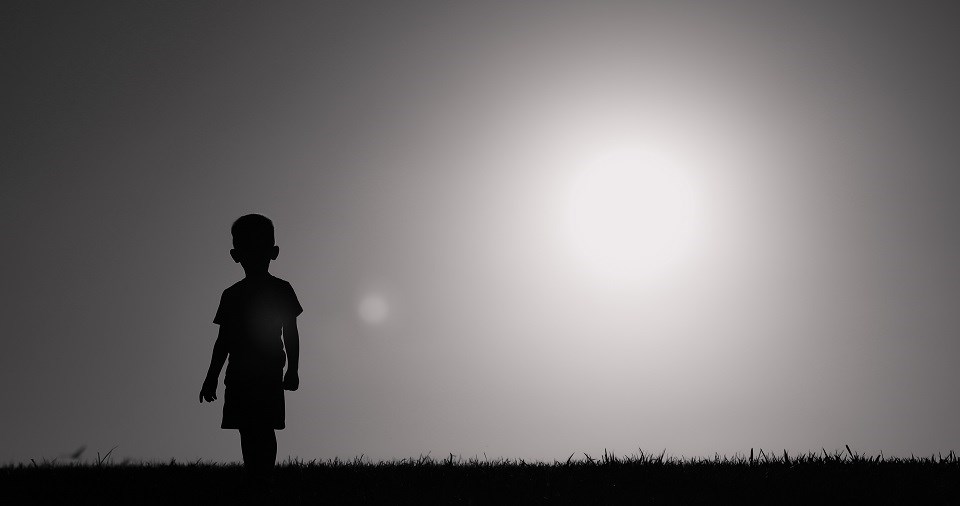 Young boy walking wandering alone - Getty Images