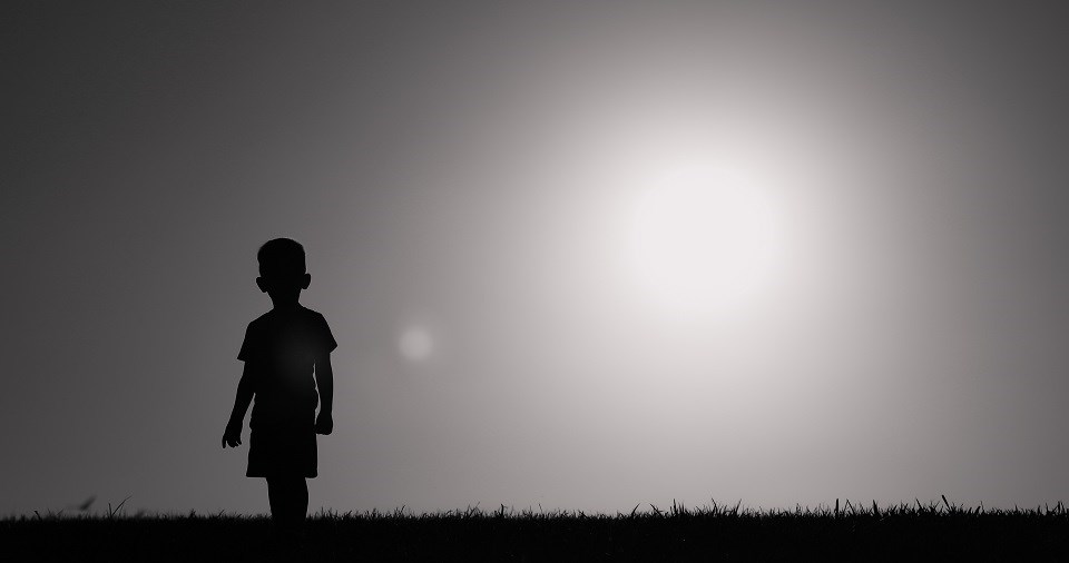 Young boy walking wandering alone - Getty Images