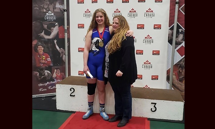 Prince George Secondary's Haley Florell stands victorious as the National wresting champion in the Under-19 women's 80kg freestyle category (via Twitter/Kap Manhas)