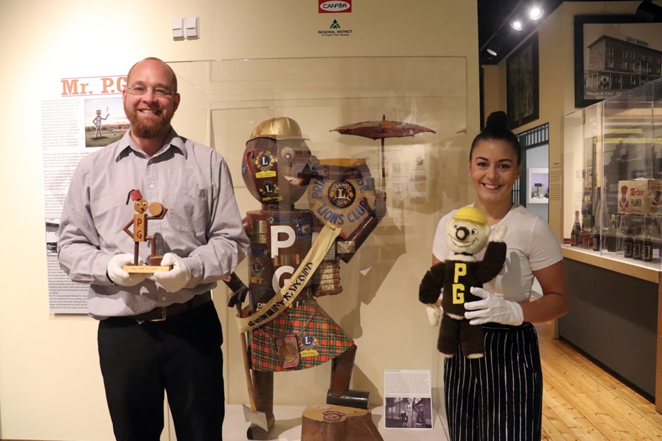 Curator Alyssa Leier (right) and assistant curator Chad Hellenius with the lost metal Scottish Mr. PG. (via Hanna Petersen) 