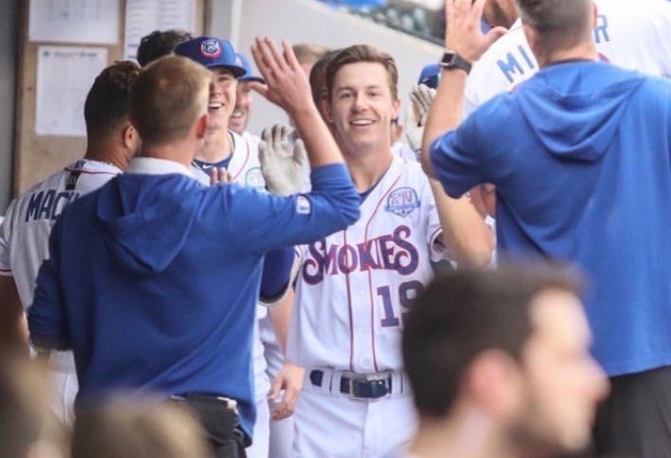 Prince George's Jared Young (#19) high-fives his Tennessee teammates in the home dugout (via Instagram/Jared Young)