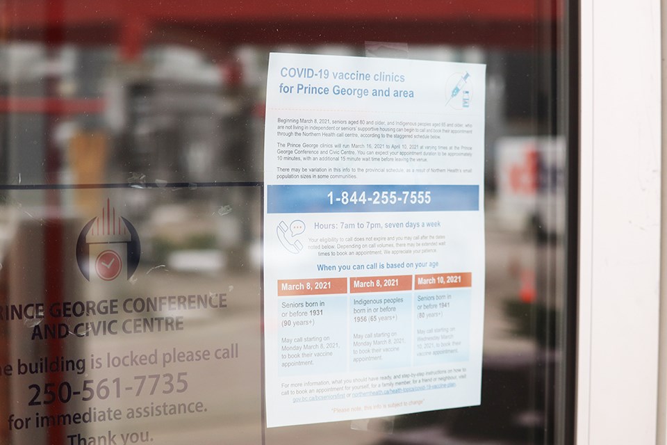 Signs on the door outside the Prince George Civic and Conference Centre where the first large scale vaccination clinic in the city is located. 