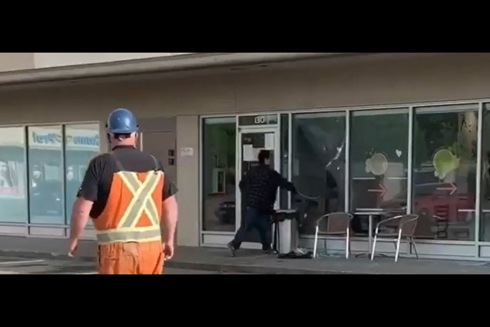 An individual appears to be smashing windows with tables at Second Cup Coffee Co. in Prince George's Parkwood Mall on Aug. 19, 2020. (via Screenshot/Supplied video)