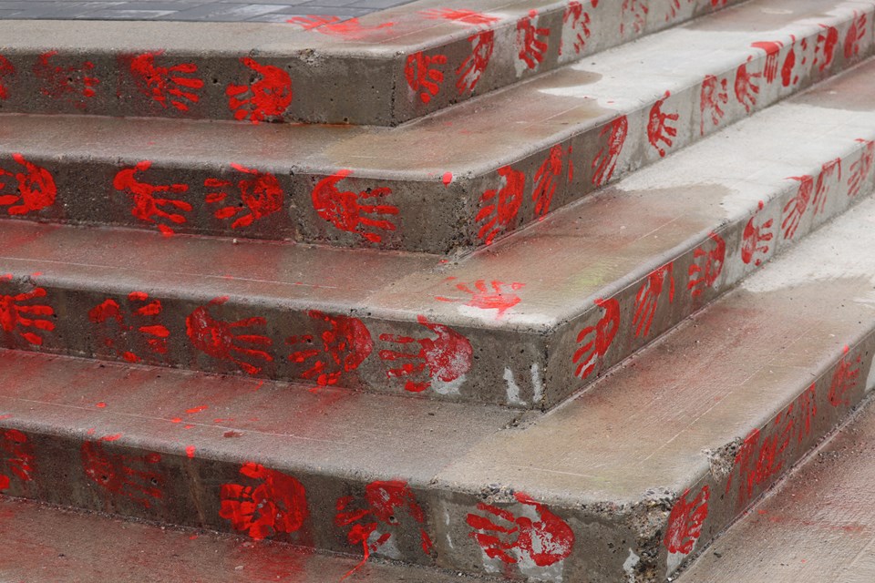 The Prince George courthouse covered in red hand prints. (via Jessica Fedigan)