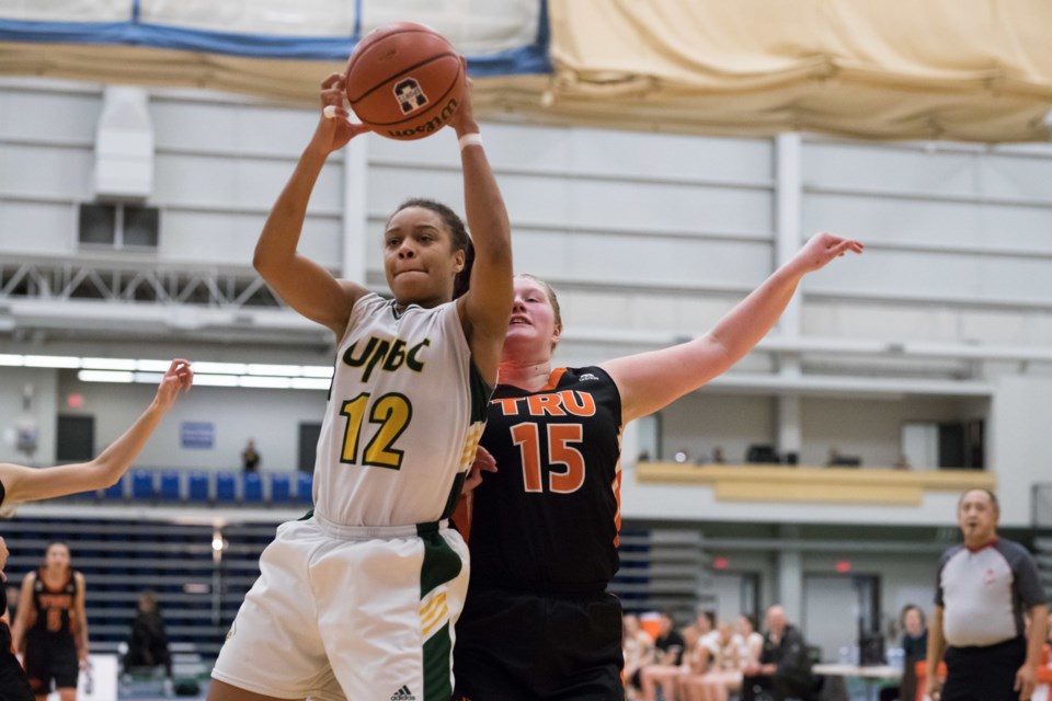 Maria Mongomo (#12) grabs the rebound for the UNBC Timberwolves during a game against Thompson Rivers. (via UNBC Athletics)