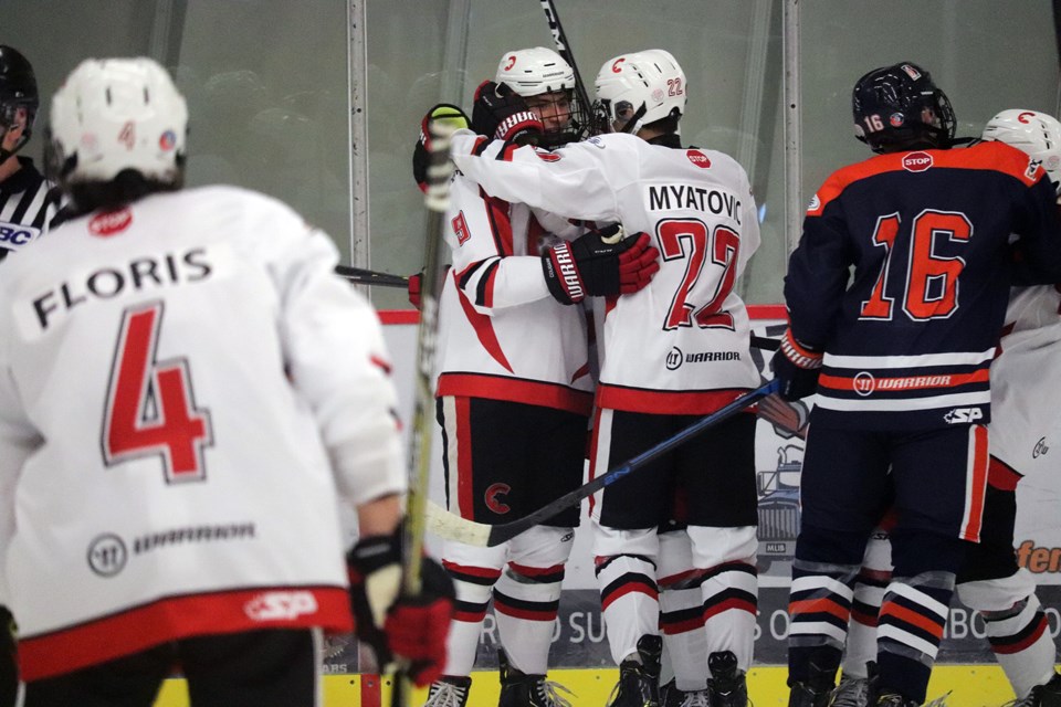 Alex Ochitwa (#8) is embraced by Nico Myatovic (#22) after scoring a goal for the Cariboo Cougars against the Thompson Blazers (via Kyle Balzer)