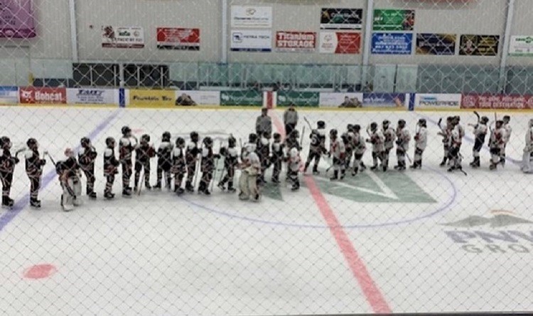 North Central Bantam AA Bobcats shake hands after a game against the Yukon Rivermen in Whitehorse (via Cariboo Hockey)