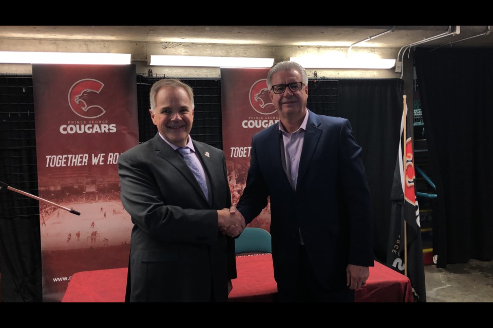 Prince George Cougars' VP of Business Andy Beesley (left) shakes hands with Mayor Lyn Hall after signing a six-year CN Centre rental renewal on June 6, 2019 (via Kyle Balzer)