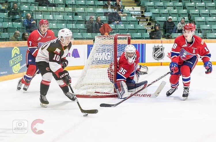 Josh Curtis (#10) attempts a wrap-around shot against the Spokane Chiefs at the CN Centre (via Prince George Cougars/James Doyle Photography)