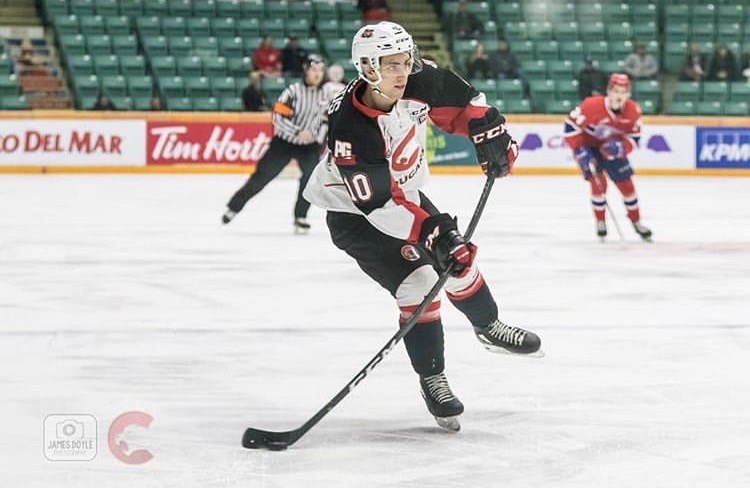 Captain Josh Curtis (#10) looks to pass the puck in a game against the Spokane Chiefs at the CN Centre (via Prince George Cougars/James Doyle Photography)