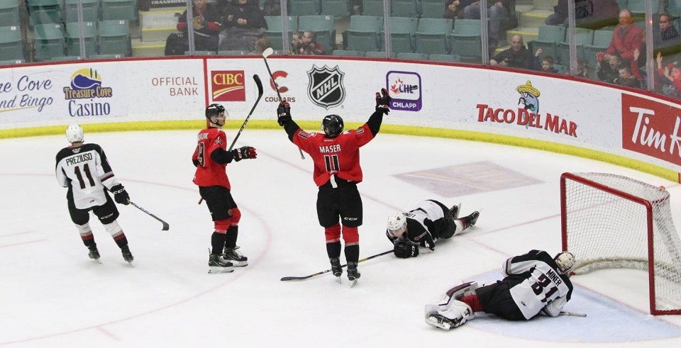 Prince George Cougars captain Josh Maser (#11) scores a goal at home against the Vancouver Giants. (via Chuck Chin Photography)