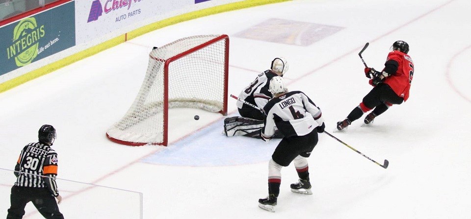 Cole Moberg (#2) scores the overtime-winning goal for the Prince George Cougars against the Vancouver Giants on home ice on March 7, 2020. (via Chuck Chin Photography)