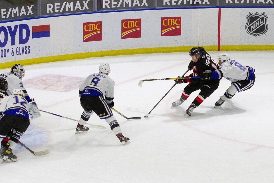 Prince George Cougars' Jonny Hooker (#18) sweeps the puck towards the middle of the offensive zone ahead of scoring a goal against Victoria during the 2020-21 B.C. Division hub season.