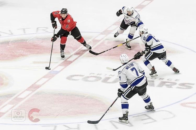 Jackson Leppard (#8) stickhandles as three Victoria Royal defenders close in at the CN Centre (via Prince George Cougars/James Doyle Photography)