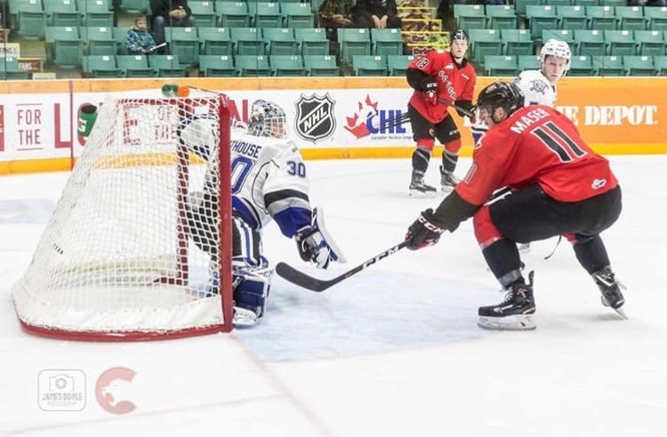 Josh Maser (#11) tips the puck inside the Victoria crease during a home game at the CN Centre (via Prince George Cougars/James Doyle Photography)