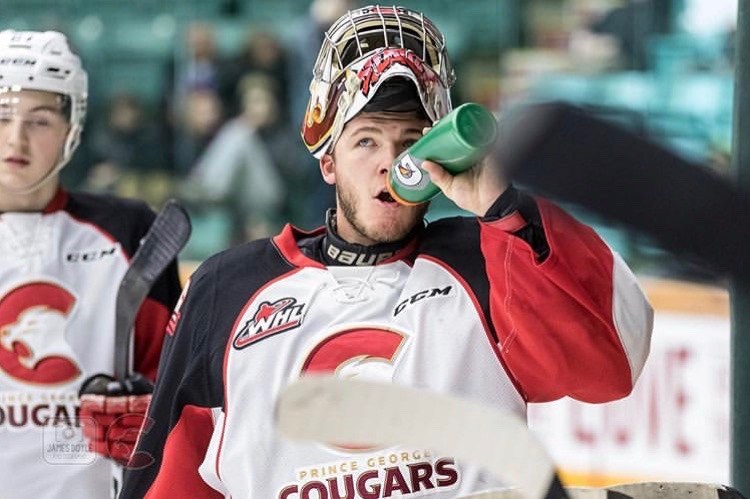Goaltender Isaiah DiLaura gets a drink of water during a break at the CN Centre (via Prince George Cougars/James Doyle Photography)