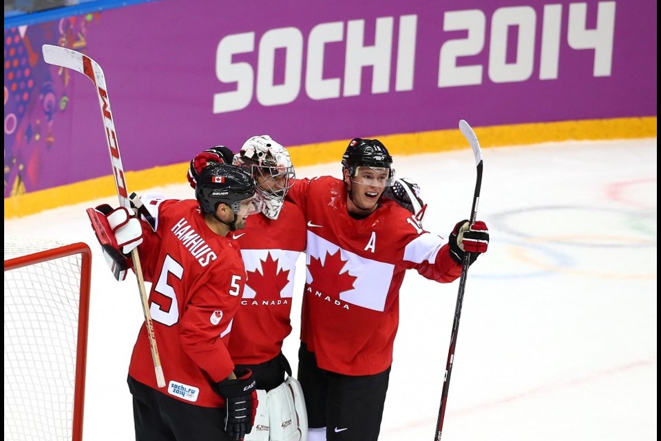 Dan Hamhuis (#5) celebrates a victory with Canada at the Sochi 2014 Winter Olympics. (via Getty Images)