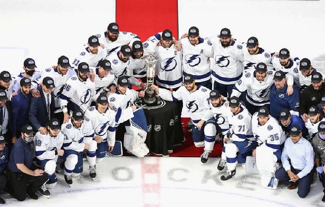 Prince George's Jon Cooper (left) poses for a photo with the Prince of Wales Trophy as 2020 Eastern Conference champions and on to the Stanley Cup Final. (via NHL/Getty Images)