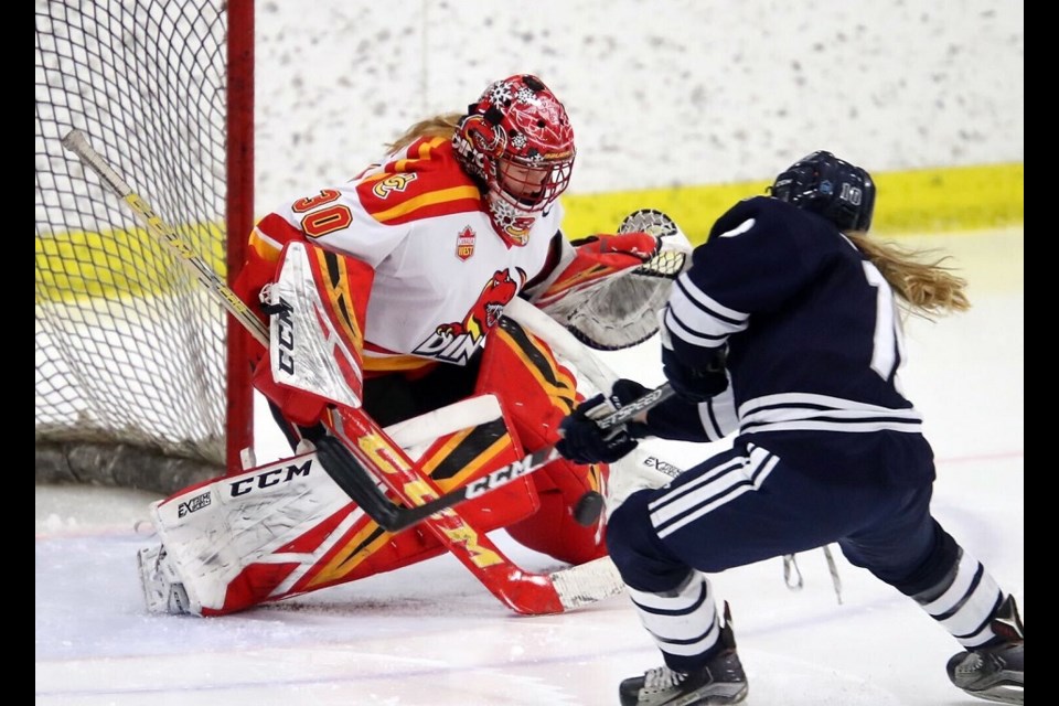 Former Northern Capitals' goaltender Kelsey Roberts (#30) makes a save for the Calgary Dinos against Mount Royal in Canada West hockey action. (via University of Calgary Athletics)