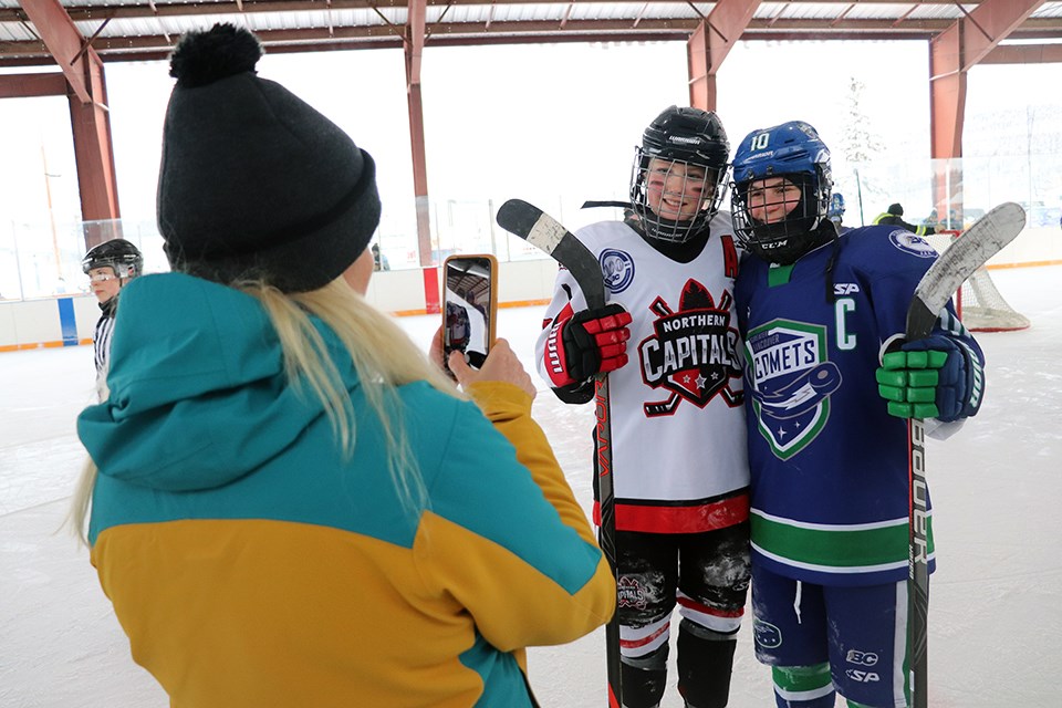 Northern Capitals' Brette Kerley (#8) poses for a photo with Greater Vancouver Comets captain Jenna Buglioni (#10) in the 2020 BC Winter Classic (via Kyle Balzer)