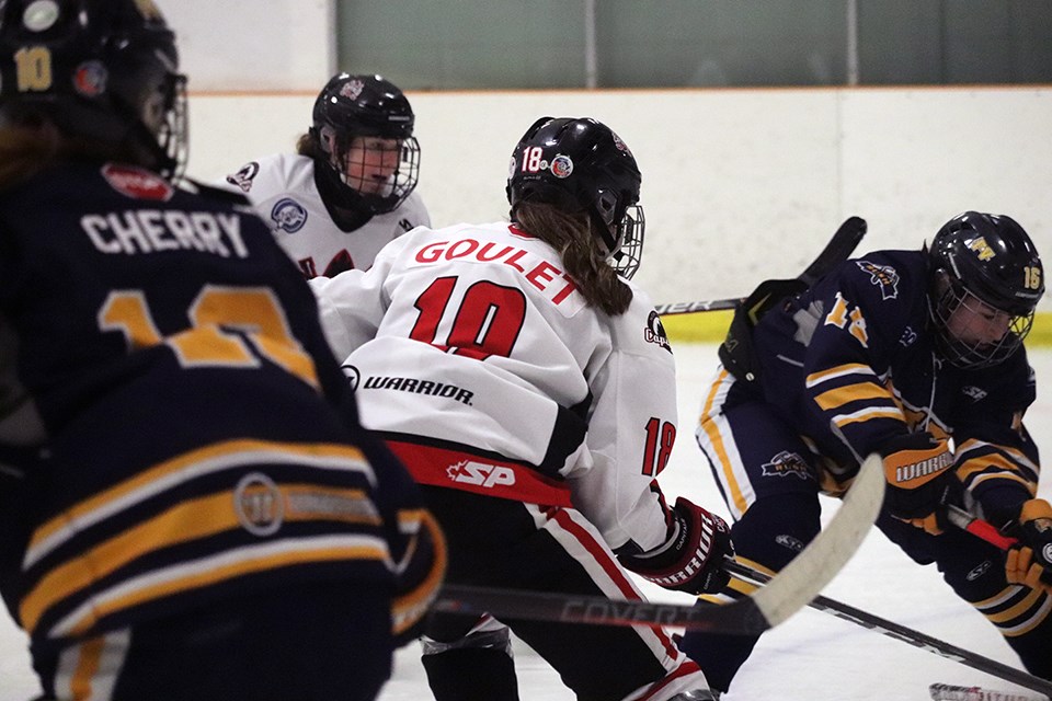 Keagan Goulet (#18) of the Northern Capitals us surrounded by defenders during her team's final 2019-20 weekend series played on home ice against the Fraser Valley Rush (via Kyle Balzer)