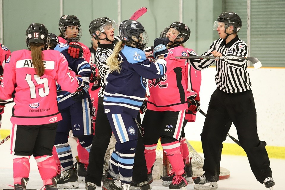 Northern Capitals' Paige Outhouse (#7) gets nudged by a Laker during Pink in the Rink Night (via Sharon Wells)