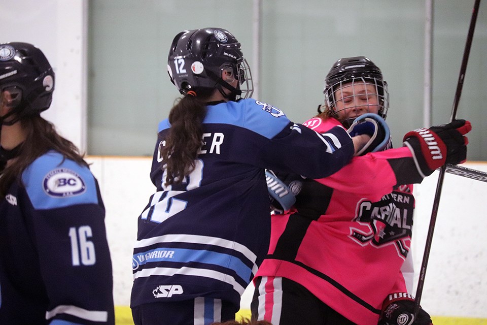 Paige Outhouse (#7), captain of the Northern Capitals, gets shoved by a Thompson-Okanagan Laker on home ice (via Kyle Balzer)