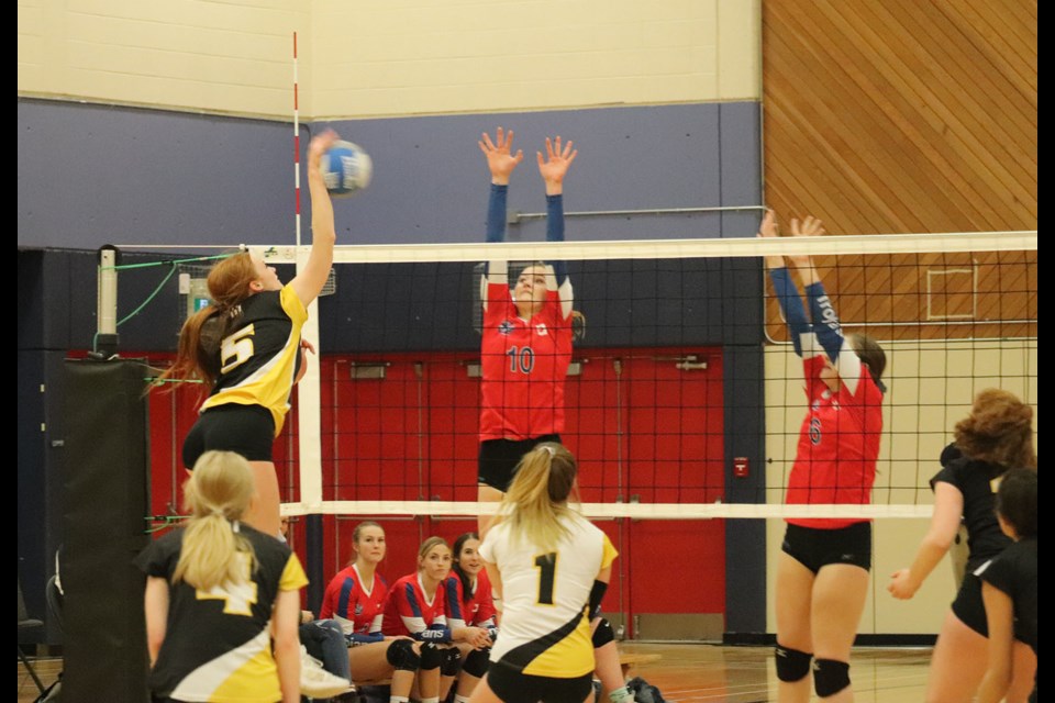 Duchess Park's Macyn Unger (#5) goes for the kill with D.P. Todd's Syerra Ferguson (#10) gets ready to block in the 2019 Prince George senior girls volleyball city championship. (via Kyle Balzer, PrinceGeorgeMatters)