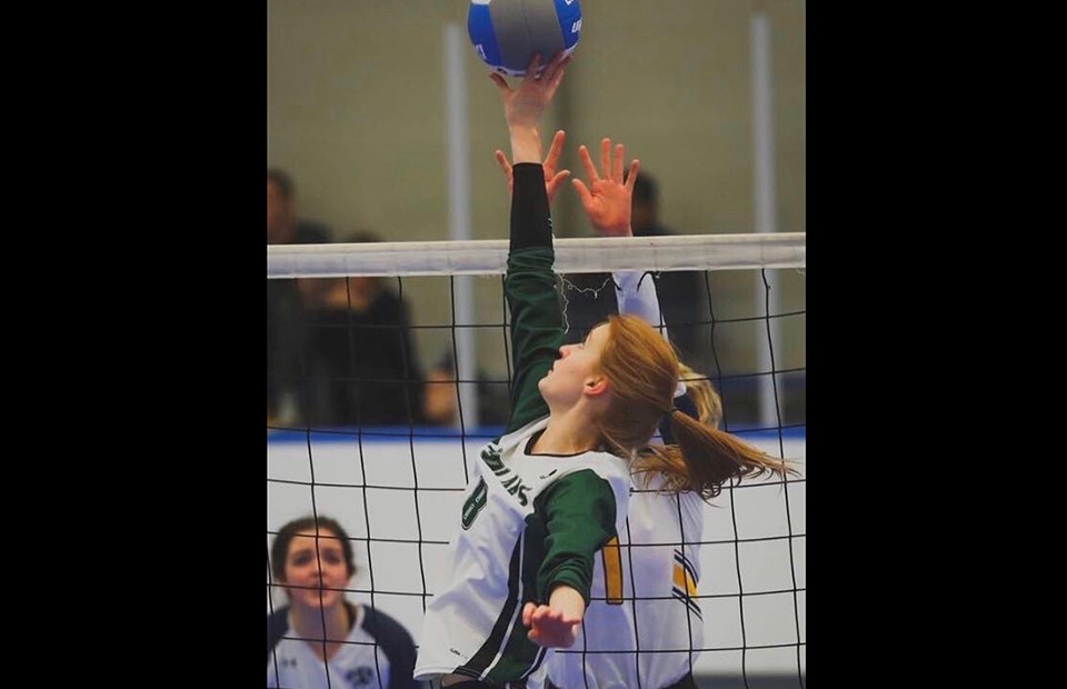 Prince George's Sophie O'Rourke reaches up at the net during a set at the 2019 BC Secondary School Volleyball Provincial Championships with the PGSS Polars.