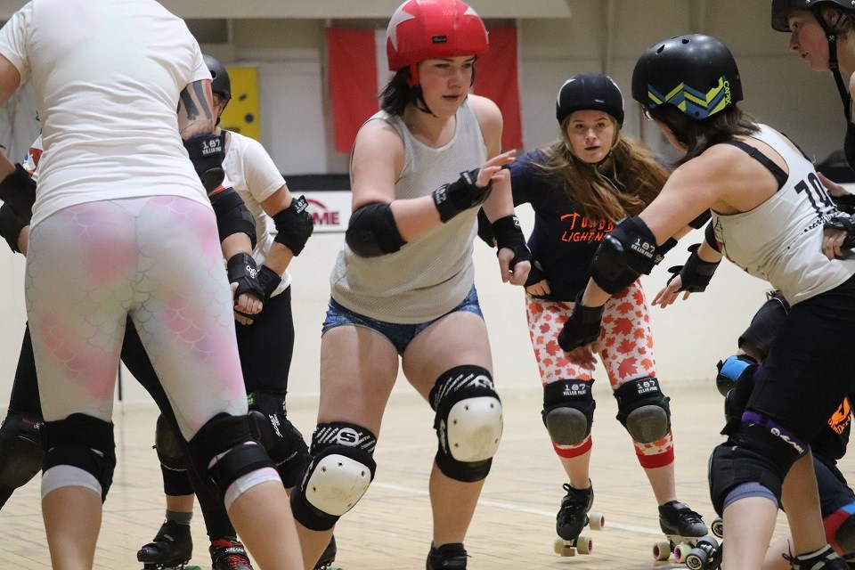 Dael King-Smith (2nd right), aka Tundra, and Taylor Robinson (middle), aka Lightning, in practice with Prince George's best roller derby athletes (via Kyle Balzer)