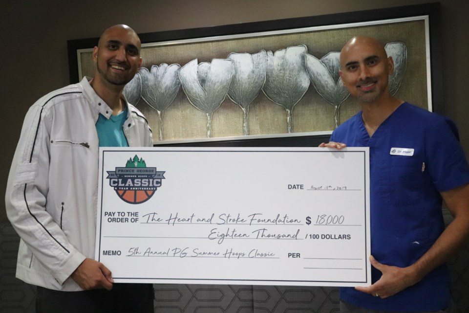 Prince George Summer Hoops Classic Organizer Nav Parmar (left) stands proudly with cousin Dr. Nav Mann, holding a cheque for $18,000 to the Heart and Stroke Foundation of Canada (via Kyle Balzer)