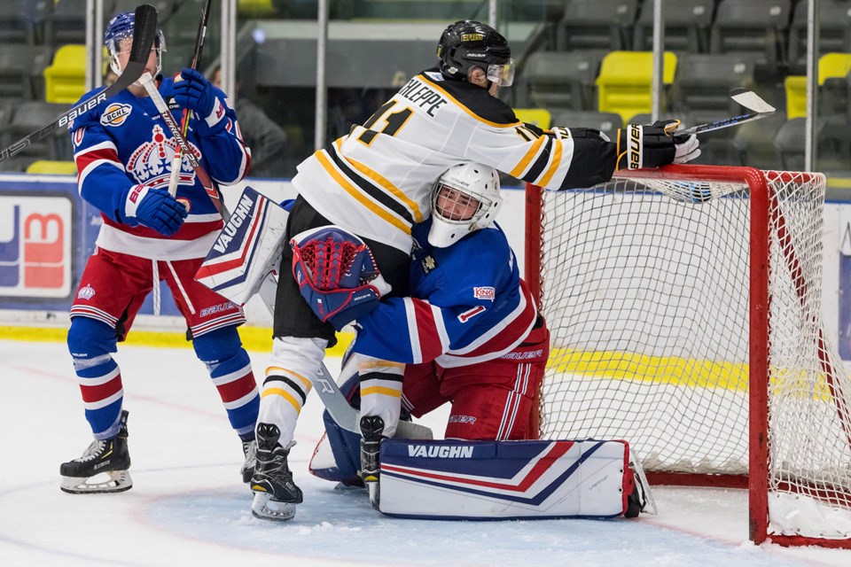 Jack McGovern (#1), goaltender for the Prince George Spruce Kings, gets bumped into against the Coquitlam Express on the road (via Damon James Photography)