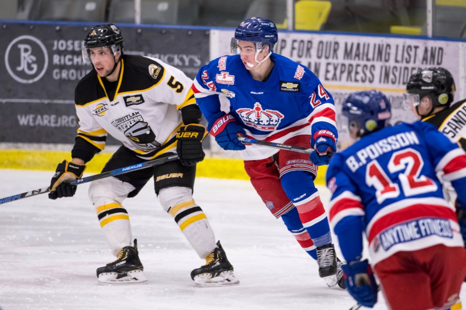 Nick Poisson (#24) of the Prince George Spruce Kings eyes the open puck while brother Ben (#12) looks on during a 2019 playoff game in Coquitlam (via Damon James Photography)