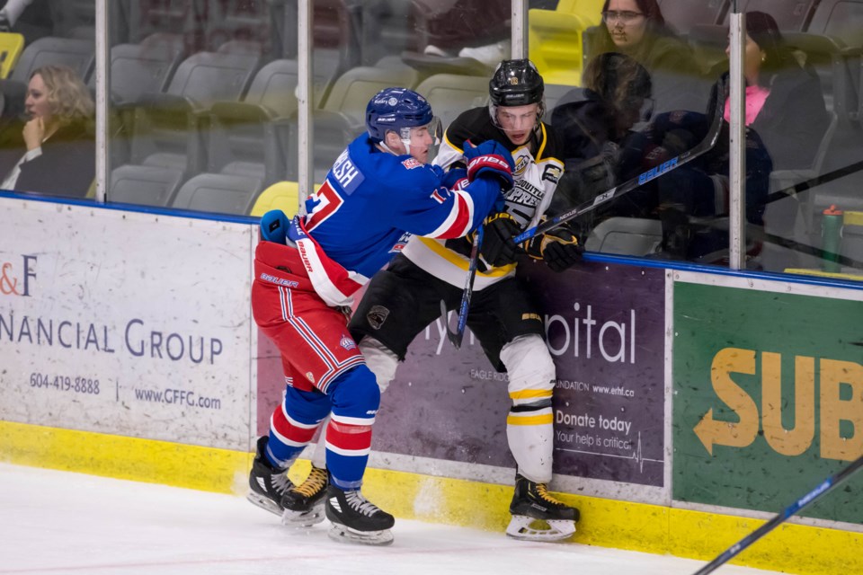 Prince George Spruce Kings' Nolan Welsh (#17) body-checks a player into the boards during a 2019 playoff game in Coquitlam (via Damon James Photography)