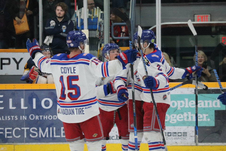 Ben Brar (#18) is mauled by his Prince George Spruce Kings teammates after scoring a goal in Game Two of the 2019 Fred Page Cup Final (via Kyle Balzer)