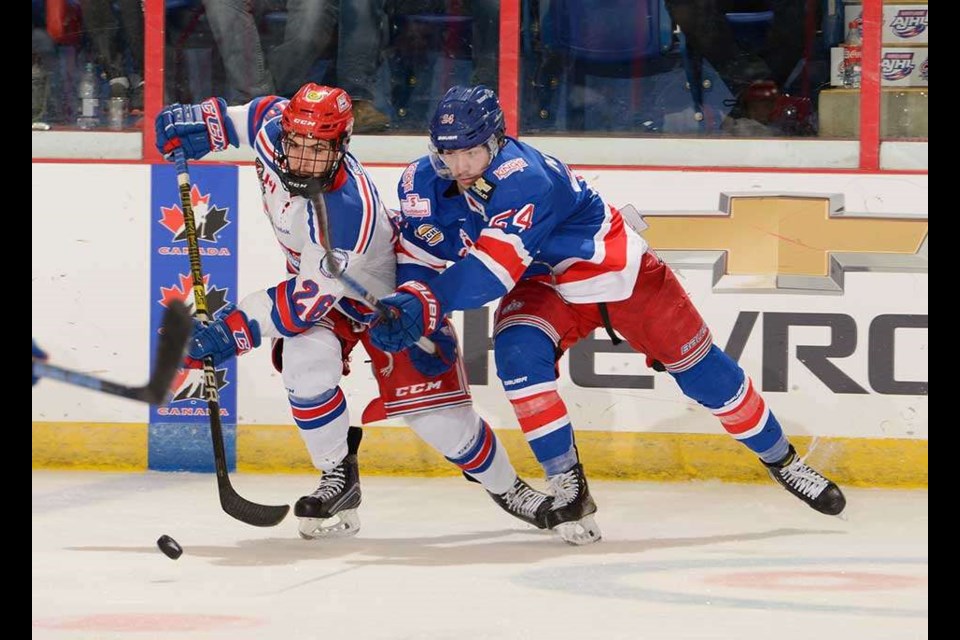 Nick Poisson (#24) tries to poke the puck away from the Oakville Blades during the Prince George Spruce Kings' 2019 National Championship semi-final match (via Hockey Canada/Matthew Murnaghan)