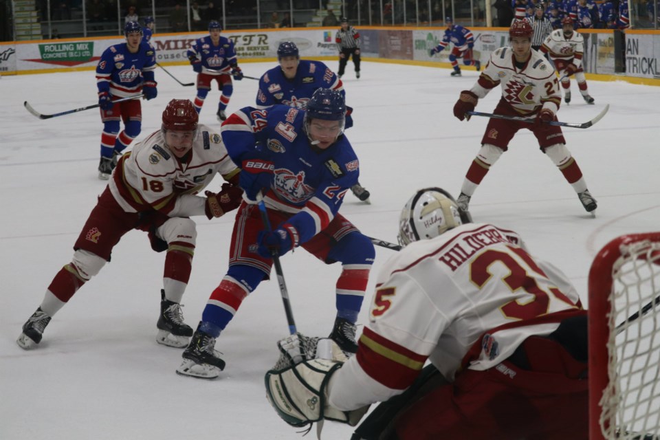 Nicholas Poisson (#24) dangles the puck for the Prince George Spruce Kings in front of the Chilliwack Chiefs net at the the Rolling Mix Concrete Arena (via Kyle Balzer)