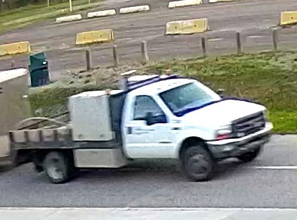 A white F-350 flatbed dully truck with a company logo on the door was seen hauling the trailer away. (via Prince George RCMP) 