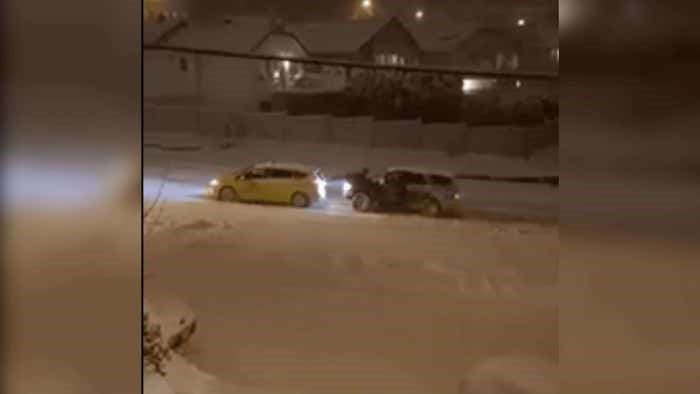 taxi being pushed through snow